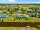 Aerial view of the house featuring a screened-in pool, lush landscaping, and beautiful backyard with canal access and a private dock at 69 Bunker Rd, Rotonda West, FL 33947