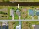 Real estate aerial view of a beautiful home with a screened-in pool and private dock along a serene canal setting at 69 Bunker Rd, Rotonda West, FL 33947