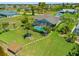 Tranquil backyard featuring a screened-in pool, private dock, waterfront access, and lush greenery, creating an ideal outdoor oasis at 69 Bunker Rd, Rotonda West, FL 33947