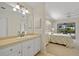 Bright bathroom with updated vanity, adjacent to main bedroom and lanai at 69 Bunker Rd, Rotonda West, FL 33947