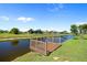 Picturesque canal view featuring a well-maintained wooden dock, perfect for relaxing by the water at 69 Bunker Rd, Rotonda West, FL 33947