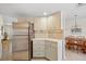 Clean, well-lit kitchen area featuring stainless steel refrigerator and adjacent dining area at 69 Bunker Rd, Rotonda West, FL 33947