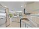 Bright kitchen featuring white cabinetry, stainless steel appliances, and a breakfast bar at 69 Bunker Rd, Rotonda West, FL 33947