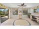 Comfortable living room with desk, sliding glass doors, and floral curtains at 69 Bunker Rd, Rotonda West, FL 33947