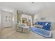 Bright and airy living room with tile flooring and comfortable furnishings at 69 Bunker Rd, Rotonda West, FL 33947