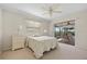 Inviting main bedroom with ceiling fan and sliding glass door to lanai at 69 Bunker Rd, Rotonda West, FL 33947