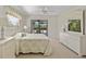 Bright main bedroom featuring lanai access and dresser for storage at 69 Bunker Rd, Rotonda West, FL 33947