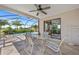 Enclosed patio features tile flooring, ceiling fan, and sliding glass doors leading to the home's interior, plus a lovely pool view at 69 Bunker Rd, Rotonda West, FL 33947