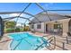 An inviting screened-in pool area with clear blue water, a charming deck, and a covered patio for relaxation and entertaining at 69 Bunker Rd, Rotonda West, FL 33947