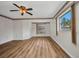 Bright and spacious main bedroom with hardwood floors and two windows at 6916 Rex Ln, Sarasota, FL 34243