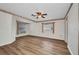 Spacious main bedroom with hard surface flooring and two windows for natural light at 6916 Rex Ln, Sarasota, FL 34243
