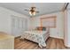 Bedroom featuring a ceiling fan, closet with bi-fold doors, and a bed with floral bedding at 6916 Rex Ln, Sarasota, FL 34243