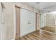 Well-lit entryway features mirrored wall, light walls, and a front door with modern fixtures at 6916 Rex Ln, Sarasota, FL 34243