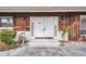 Close up on the home's front entrance with double doors, sconces, and tidy landscaping at 6916 Rex Ln, Sarasota, FL 34243