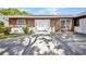 Close up on the home's front entrance with double doors and tidy landscaping at 6916 Rex Ln, Sarasota, FL 34243