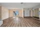 Spacious living room with a large window providing natural light and new flooring at 6916 Rex Ln, Sarasota, FL 34243