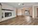 Spacious living room with a fireplace, new floors, and a large window for natural light at 6916 Rex Ln, Sarasota, FL 34243