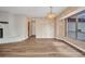 Bright living room featuring wood flooring, a decorative fireplace, and a large window at 6916 Rex Ln, Sarasota, FL 34243