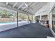 Spacious screened in lanai with an attached outdoor kitchen and bar area at 6916 Rex Ln, Sarasota, FL 34243