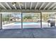 Large screened patio with a view of the backyard pool and lounging area at 6916 Rex Ln, Sarasota, FL 34243