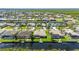 Scenic aerial view of waterfront houses with screened in patios and private docks on a sunny day at 695 Macedonia Dr, Punta Gorda, FL 33950
