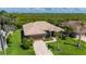 Aerial shot of a single-story home with lush landscaping and a waterfront view at 695 Macedonia Dr, Punta Gorda, FL 33950
