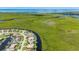 An aerial view showcases a charming waterfront home with a private boat dock on a serene canal at 695 Macedonia Dr, Punta Gorda, FL 33950
