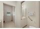Bright bathroom offering convenience to the laundry area, featuring a vanity and accessible toilet at 695 Macedonia Dr, Punta Gorda, FL 33950