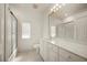 Bathroom featuring a large mirror, vanity with white cabinetry, and glass-enclosed shower at 695 Macedonia Dr, Punta Gorda, FL 33950