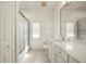 Bathroom featuring a large mirror, vanity with white cabinetry, and glass-enclosed shower at 695 Macedonia Dr, Punta Gorda, FL 33950