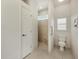 Bright bathroom featuring a tiled shower with glass block window and white commode with shuttered window at 695 Macedonia Dr, Punta Gorda, FL 33950
