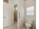Bright bathroom features a shower and a toilet under a window with plantation shutters at 695 Macedonia Dr, Punta Gorda, FL 33950
