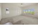 Bright bedroom with carpet, ceiling fan, and windows with plantation shutters at 695 Macedonia Dr, Punta Gorda, FL 33950