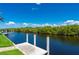 Waterfront view from dock featuring a tranquil canal and lush greenery along the banks at 695 Macedonia Dr, Punta Gorda, FL 33950