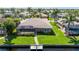Well-maintained waterfront home with a private dock, screened enclosure, and lush landscaping in a quiet neighborhood at 695 Macedonia Dr, Punta Gorda, FL 33950