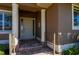 The front door to this home is flanked by columns and leads to the home's interior through a brick landing and walkway at 695 Macedonia Dr, Punta Gorda, FL 33950