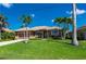 Inviting single-story home features a well-kept lawn, mature landscaping, and a two-car garage for ample parking space at 695 Macedonia Dr, Punta Gorda, FL 33950