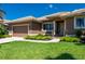 Attractive single-Gathering home showcasing a manicured lawn, colorful landscaping, and a convenient two-car garage at 695 Macedonia Dr, Punta Gorda, FL 33950