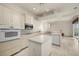 Updated kitchen with white cabinets, stainless steel appliances and a center island at 695 Macedonia Dr, Punta Gorda, FL 33950