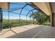 Spacious lanai with brick flooring and beautiful waterfront views from behind the screen at 695 Macedonia Dr, Punta Gorda, FL 33950