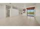 Bright, open-concept living room with tile floors and sliding glass doors to the patio at 695 Macedonia Dr, Punta Gorda, FL 33950