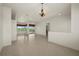 Spacious living room with tile flooring, open floorplan, and sliding glass doors at 695 Macedonia Dr, Punta Gorda, FL 33950