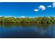 Waterfront featuring a canal, lush vegetation, and serene water at 695 Macedonia Dr, Punta Gorda, FL 33950