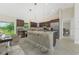 Modern kitchen with stainless steel appliances, a large island with bar seating, and tile backsplash at 7381 De Brita Rd, North Port, FL 34291