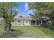 Large backyard surrounded by mature trees with lush green lawn perfect for outdoor activities and enjoyment at 7448 S Blue Sage, Punta Gorda, FL 33955