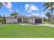Charming home with lush lawn, freshly mulched planting beds, and a dark-colored two-car garage at 7448 S Blue Sage, Punta Gorda, FL 33955