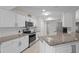 Modern kitchen with stainless steel appliances, white cabinets, and granite countertops at 7448 S Blue Sage, Punta Gorda, FL 33955