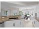 Well-lit kitchen with granite countertops, white cabinets, and a breakfast nook with backyard views at 7448 S Blue Sage, Punta Gorda, FL 33955