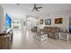 Bright and airy living room featuring tile flooring, comfortable furniture, and a ceiling fan at 7448 S Blue Sage, Punta Gorda, FL 33955