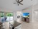 Bright living room with ceiling fan and sliding glass doors opening to the lanai for seamless indoor/outdoor living at 7448 S Blue Sage, Punta Gorda, FL 33955